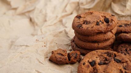 Flatview of handcrafted chocolate cookies with chocolate chips on baking paper