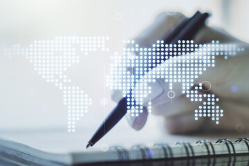 Abstract creative digital world map and woman hand writing in diary on background, globalization concept. Multiexposure