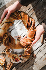 Sweet Bread Wreath. Eastern Europe cuisine concept. Homemade baking. Top view delicious dessert on wooden rustic table