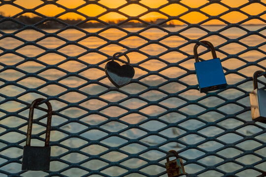 Locks of love on the fence nid at sea and dawn. Helsinki