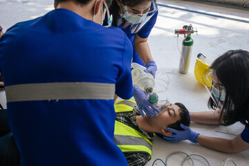 Team work medical emergency use Automated External Defibrillator (AED) being operated on during...