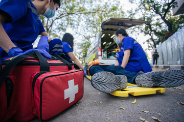 Selective focus is first aid bag. Team paramedic firs aid accident on road. Ambulance emergency...