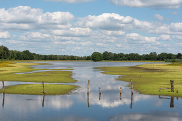 Beautiful lake scenery with clouded sky and the reflection of the clouds in the water