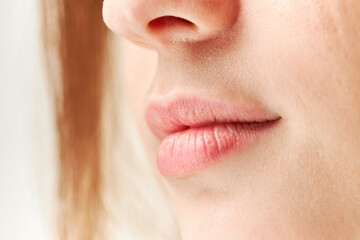 Obraz premium Part of face,young woman close up. Plump lips without makeup