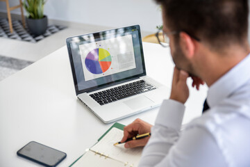 Businessman sitting at desk and working on his computer