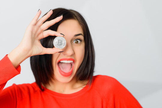  girl holding bitcoin like monocle with OK ring gesture - Powered by Adobe