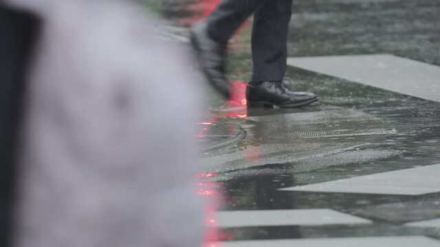 Close Up Of Salary Man Or Office Worker Shoes Running Across The Road In Rain. Tokyo, Japan Slow Motion.