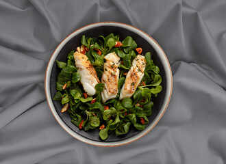 grilled fish steak with vegetable salad on plate gray background 