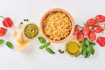 Spaghetti, fresh tomato, herbs and spices. Composition of healthy food ingredients isolated on white background, top view. Mock up.