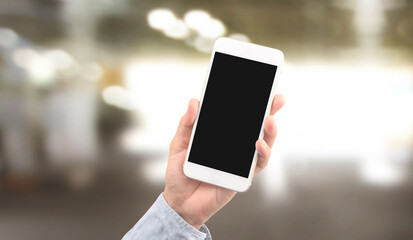 Hand holding smartphone device touching screen