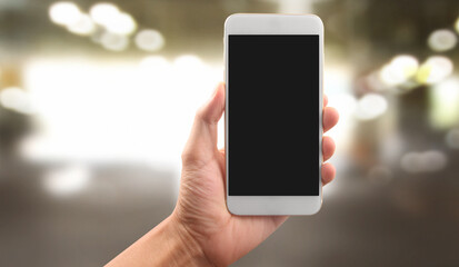 Hand holding smartphone device touching screen