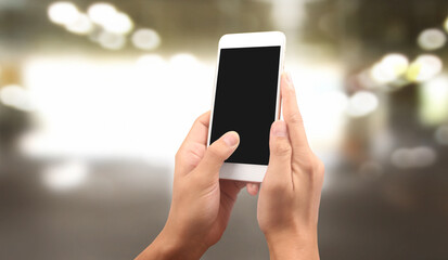 Hand holding smartphone device touching screen