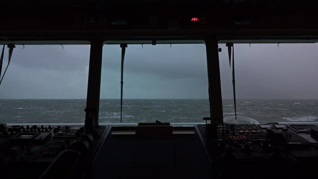 Sea view from the bridge of the ship. Storm. The ship is rocking. High waves. White foam on the water. Windshield wiper works. - Powered by Adobe