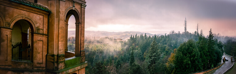 panoramic view of Colli Bolognesi hills at sunset from the arcades San Luca basilica, horizontal background of Bologna in Italy