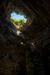 La Grave abyss of Grotte di Castellana with ray of sunlight in Puglia