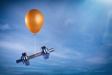 Hantel schwebt an Ballon in der Luft