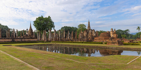 Wat mahathat temple with reflection on a pond in Sukhothai Historical Park, which also one of UNESCO Heritage Site