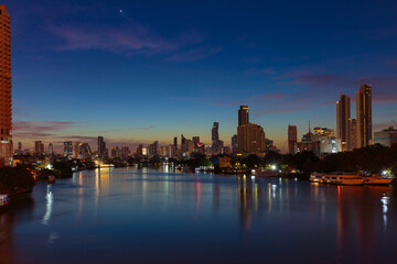 Bangkok Chaopraya river at night time with downtown building in background