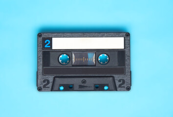 Obraz premium Retro audio cassette tape on turquoise background.