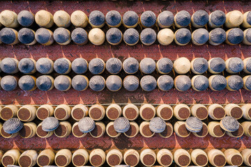 Traditional soy sauce factory, aerial view of the fermented field with numbers of earthen jars on the ground, where soya beans are fermented to produce the soy sauce which is used in Chinese cooking