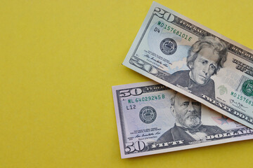 Paper dollar bills yellow background