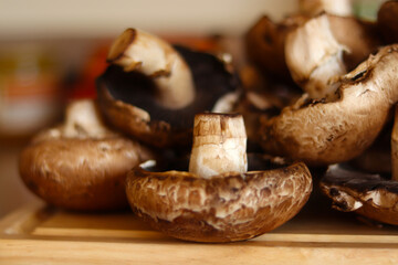 Mushrooms over kitchen wooden board. Healthy food concept.