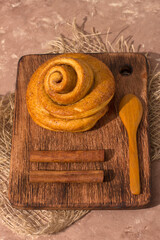Freshly baked cinnamon bun stuffed with spices and cocoa . Sweet homemade cakes.