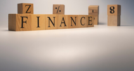 The word finance is from wooden cubes. Background from wooden letters.