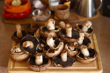 Mushrooms over kitchen wooden board. Healthy food concept.
