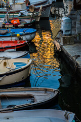 boats aligned along harbour in Genoa Italy