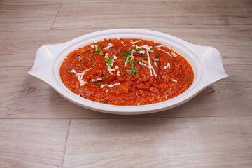 Veg Kolhapuri in black bowl on dark slate table above. Indian vegetable curry dish. Vegetarian asian food and meal. Copies space.