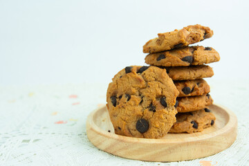 Chocolate chip cookie on wood plate