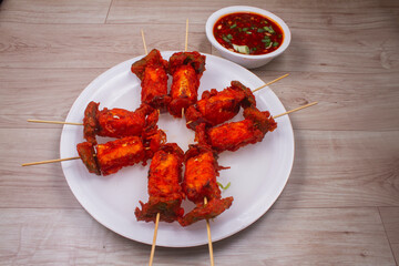paneer satay or Spicy cottage cheese, served with capsicum and onion, favorite indian starter menu, selective focus
