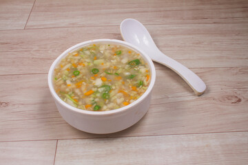 Sweet corn soup in bowl on wooden background. selective focus. stock photo.