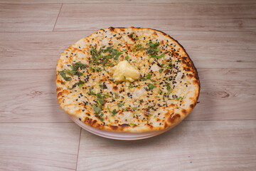 indian special flat bread also known as tandoori butter kulcha or naan, served in a white ceramic quarter plate