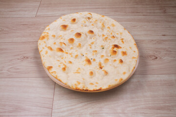 indian special flat bread also known as tandoori roti or naan, served in a white ceramic quarter plate