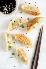Fried gyoza chinese meat dumplings served with dipping soy sauce. Top view
