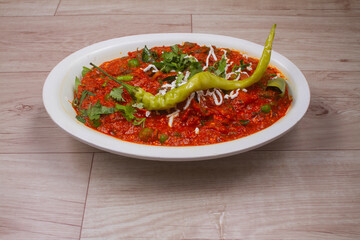 Matar paneer curry recipe with cottage cheese, green peas, served in a bowl. selective focus Delhi, Rajasthan India. Top view Indian veg curry on red background.