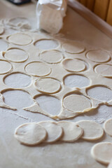 Variki with meat and mushrooms. They lie on the table. Dough.