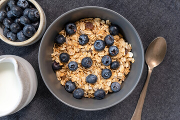 Bowl of muesli with blueberries top view. Healthy breakfast cereals