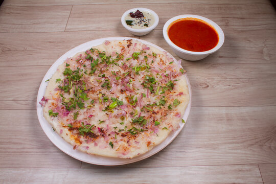 Uthappam or Uttapam is a type of dosa from southern India that is thicker, with tomato, onion, chilli packets.