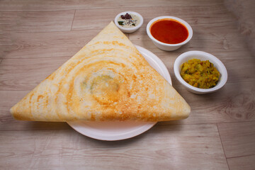 Masala dosa is a South Indian dish that is served with sambhar and coconut rubble. Selective focus