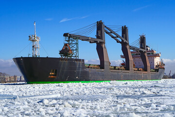 The dry cargo ship moves along the forway in the ice of the Gulf of Finland. The unit is fully...