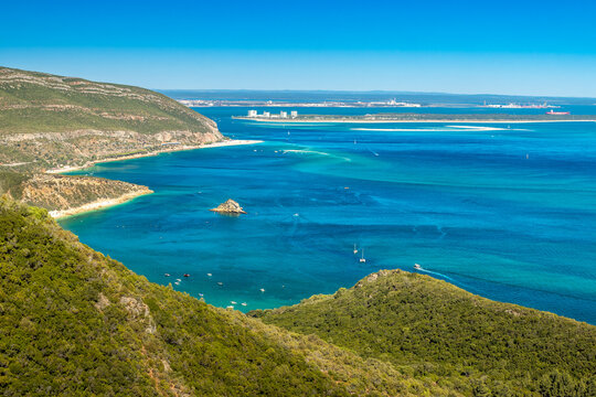 Beautiful landscape of the Arr&aacute;bida Natural Park in Portugal, with the mountains, beaches, blue sea and in the background the Tr&oacute;ia peninsula on a sunny day in summer.