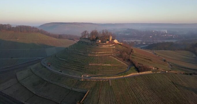Weibertreu hilltop castle in the town of Weinsberg. Aerial sunset view
