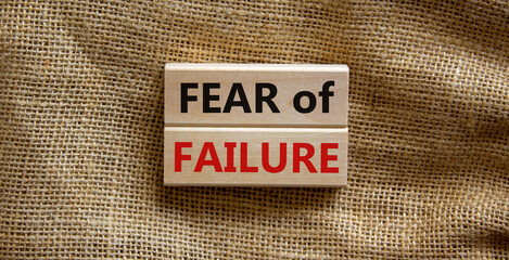 Fear of failure symbol. Wooden blocks with words 'fear of failure'. Beautiful canvas background,...