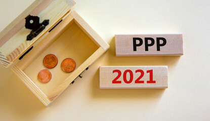 PPP, paycheck protection program 2021 symbol. Concept words PPP, paycheck protection program 2021 on wooden blocks on a beautiful white background. Small chest with coins. Business, PPP 2021 concept.