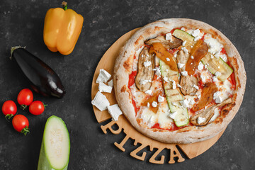 Homemade vegetarian pizza with grilled vegetables. Tomato sauce, bell pepper, eggplant, zucchini, mozzarella and cheese on a dark background. Top view, side view