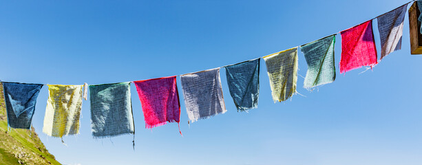 Bunte Gebetsfahnen vor Blauem Himmel