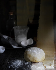 homemade yeast dough side view on rustic kitchen interior background closeup. Selective focus